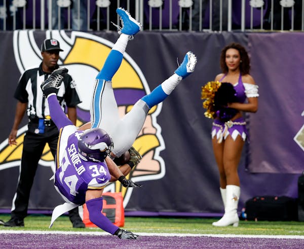 Andrew Sendejo (34) hit Golden Tate (15) as he leapt into the end zone to score the winning touchdown in overtime. Detroit beat Minnesota by a final s