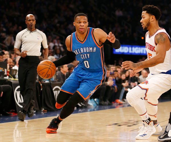New York Knicks guard Derrick Rose (25) guards Oklahoma City Thunder guard Russell Westbrook (0) as he drives to the basket in the first half of an NB