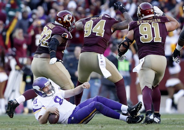 Preston Smith (94) celebrated after sacking Sam Bradford for a 14-yard loss late in the fourth quarter.
