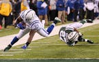 Indianapolis Colts running back Robert Turbin, left, dives in for a touchdown score after avoiding a tackle by New York Jets cornerback Darryl Roberts