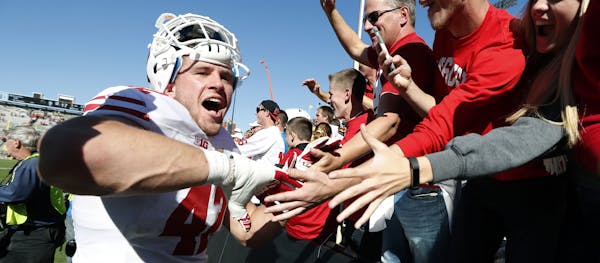 Wisconsin linebacker T.J. Watt, left, celebrates with fans after an NCAA college football game against Iowa, Saturday, Oct. 22, 2016, in Iowa City, Io