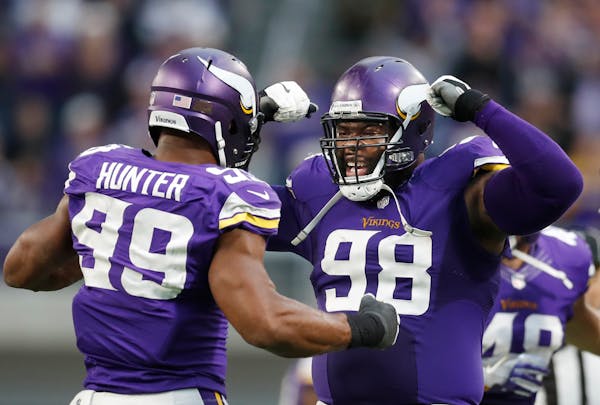 Minnesota Vikings defensive end Danielle Hunter (99) left celebrated his last sack of the game over Cardinals quarterback Carson Palmer (3) with defen
