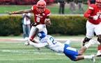 Louisville quarterback Lamar Jackson (8) gets his feet wrapped up by Kentucky's Blake McClain (24) during the first half of an NCAA college football g