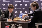Sergey Karjakin, right, makes a move during round 8 of the World Chess Championship against Magnus Carlsen, in New York, Monday, Nov. 21, 2016.