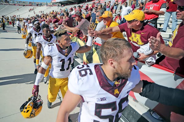 Gophers players celebrated with fans after they defeated Maryland 31-10 last month.