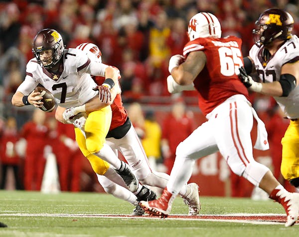 Minnesota's quarterback Mitch Leidner was sacked by Wisconsin's T.J. Watt in the fourth quarter as Minnesota took on Wisconsin at Camp Randall Stadium