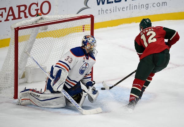 Minnesota Wild's center Eric Staal, right, scores on this shot past Edmonton Oilers' goalie Cam Talbot in the shootout.