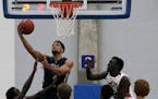 Theo John of Champlin Park goes up with the ball in a Dec. 3 game against Rochester John Marshal at Hopkins' Lindberg Center.