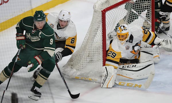 Mikko Koivu aims to score as Brian Dummoulin and goalie Marc-Andre Fleury defend.