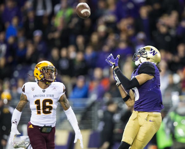 Washington wide receiver Dante Pettis brings in a pass from Jake Browning for a 46-yard touchdown in front of Arizona State defensive back Maurice Cha