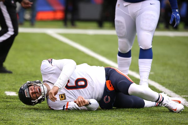 Chicago Bears quarterback Jay Cutler (6) lays on the ground after taking a late hit from New York Giants defensive end Olivier Vernon (54) in the firs