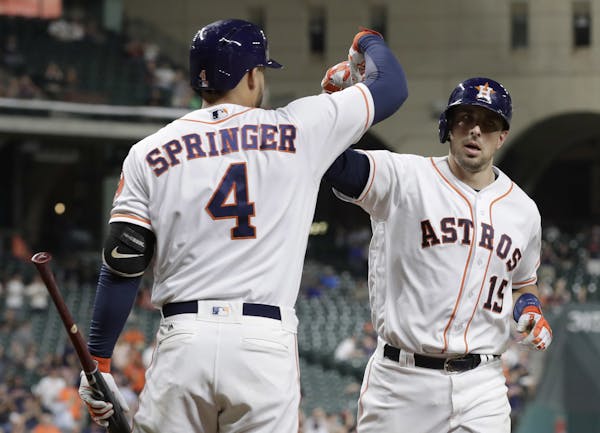 Jason Castro, right, and his former teammate George Springer were part of a group that turned the Astros from losers of 92 games in 2014 into contende