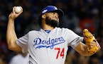 FILE - In this Oct. 22, 2016, file photo, Los Angeles Dodgers relief pitcher Kenley Jansen (74) throws during the sixth inning of Game 6 of the Nation