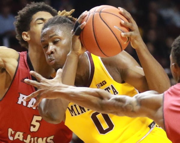 The Gophers’ Akeem Springs, driving on Louisiana-Lafayette’s Kadavion Evans on Friday, knows all about midmajors winning at Williams Arena; he did