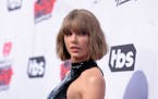In this April 2016 file photo, Taylor Swift arrives at the iHeartRadio Music Awards at The Forum in Inglewood, Calif.