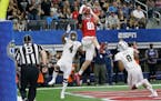 Wisconsin tight end Troy Fumagalli (81) catches a touchdown pass against Western Michigan defenders Darius Phillips (4) and Caleb Bailey (8) during th