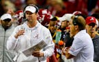 Alabama offensive coordinator Lane Kiffin makes a play call as head coach Nick Saban watches during the first half of the Peach Bowl NCAA college foot