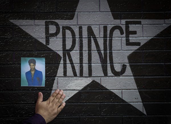 A hand reached out to touch Prince’s star at First Avenue on April 21, 2016, the day he was found dead.