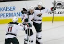 Minnesota Wild center Eric Staal (12) celebrates his goal with teammates Nino Niederreiter (22) and Zach Parise (11) during the third period of an NHL