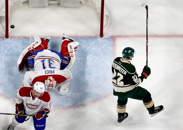 Nino Niederreiter (22) celebrated after shooting the puck past Montreal goalie Carey Price (31) for a goal in the third period.
