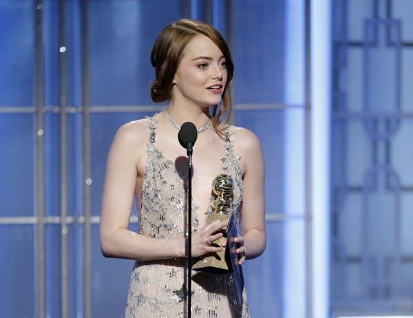 This image released by NBC shows Emma Stone with the award for best actress in a motion picture comedy or musical for her role in "La La Land" at the 