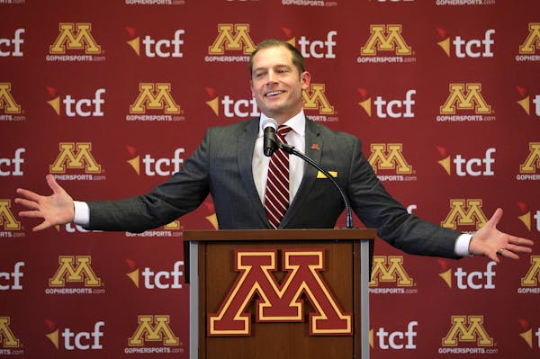 Newly named University of Minnesota football coach P.J. Fleck gestured as he spoke during a press conference Friday.