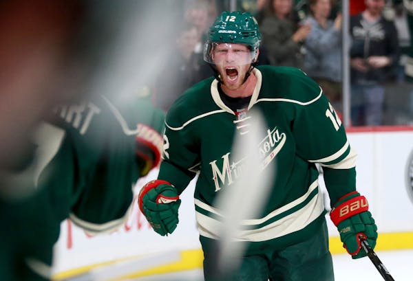 Eric Staal celebrates near the Wild bench after scoring the go-ahead goal in the season's home opener against Winnipeg.