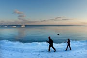 To stay fit during cold weather, embrace winter sports such as cross-country skiing. Lake Superior provided a nice backdrop for this couple.