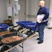 Nick Stafford waits for his number to be called Wednesday, Jan. 11, 2017, as he stands beside of 5 wheelbarrows full of change, mostly pennies, at the