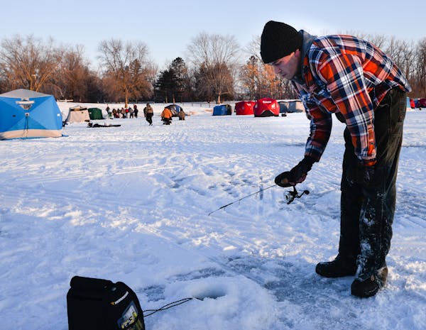 Chris Toll fished outside of his ice house well on Courthouse Lake in Chaska for the trout opener on Jan. 14.