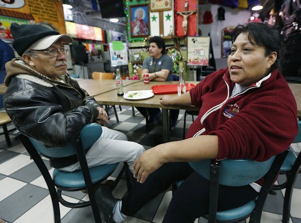 During lunch at Lake Plaza market in Minneapolis, Jose Quiroz Cantoran, left, and Candida Mendez talked about President Trump’s policies as they wat