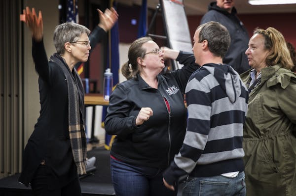 Trainer Debra Prokopf of Minnesota Association of Professional Employees, center in black, plays out a potential scenario as a counter protester durin