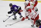Red Wing forward Nick Ramstad (25) battled several Austin players for the puck in the Wingers' 5-3 victory in Big Nine Conference boys' hockey Thursda