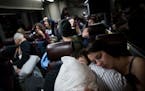 Alicia Rangel Cypher and her daughter Chasity Cypher snuggle as they slept on a bus to the Women's March on Washington from Minnesota early Saturday m