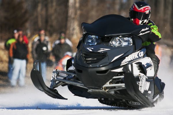 FILE - In this Jan. 6, 2013, file photo, Mike Martin, of Galesburg, Ill., drives his Arctic Cat snowmobile during the Annual Prairie Drifters Snowmobi