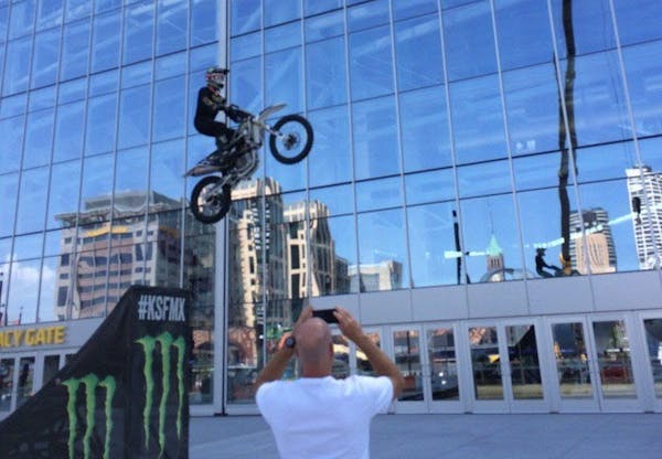 A motorcyclist performs stunts outside U.S. Bank Stadium last summer as officials announced Minneapolis will host the summer X Games in 2017 and 2018.