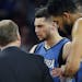Minnesota Timberwolves guard Zach LaVine is helped off the court during the second half of the team's NBA basketball game against the Detroit Pistons,