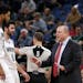 Minnesota Timberwolves head coach Tom Thibodeau talks with Timberwolves center Karl-Anthony Towns (32) and guard Ricky Rubio (9)