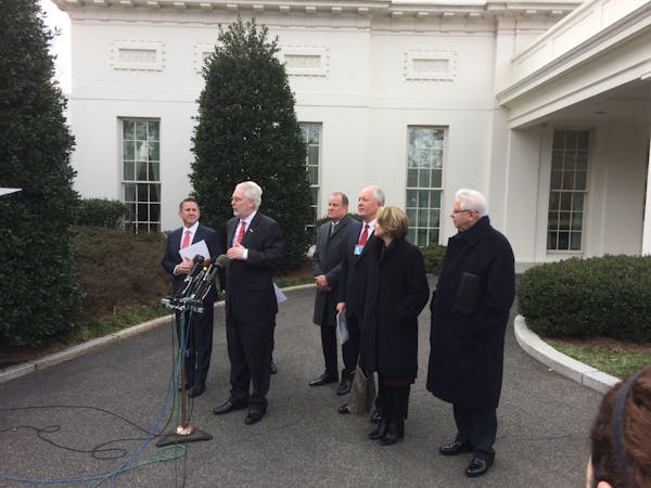 Autozone CEO Bill Rhodes, at the microphone, and Target CEO Brian Cornell, at left, and other executives visited the White House in February to raise 