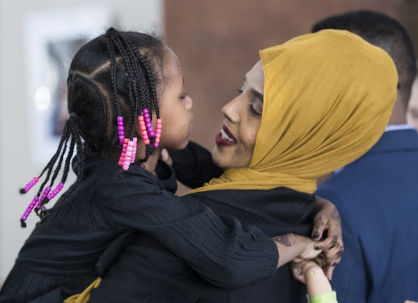 Mushkaad Abdi, 4, held tight to her mother, Samira Dahir, after Friday's news conference in Minneapolis at Lutheran Social Service.