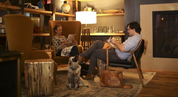 Bri and Matt Sharkey-Smith of Minneapolis relaxed with dog Ellie Mae in the lounge of the Hewing Hotel, a North Loop hot spot.