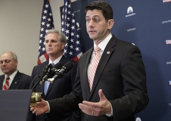 House Speaker Paul Ryan of Wis., right, gave a strong defense of President Donald Trump's refugee and immigration ban to caucus members and said he ba