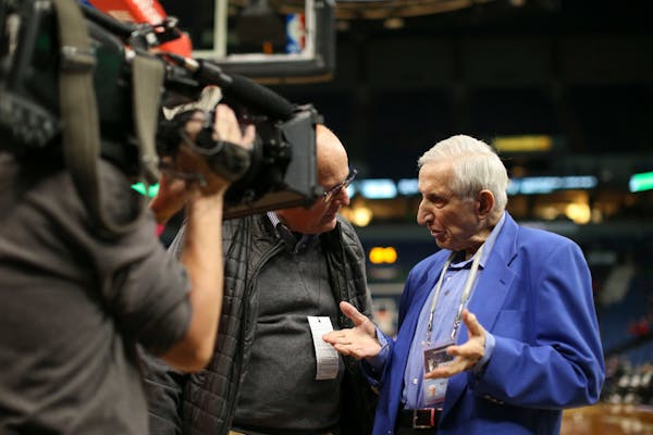 Star Tribune columnist Sid Hartman, right, is interviewed by Today Show correspondent Harry Smith, left, before a Timberwolves game in February.