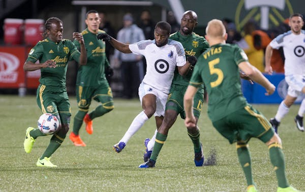 Minnesota United midfielder Kevin Molino (18) passes during the first half of an MLS soccer game against the Portland Timbers in Portland, Ore., Mar. 