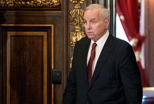 Gov. Mark Dayton headed to a news conference Thursday at the State Capitol, where the stadium panel resignations were discussed.