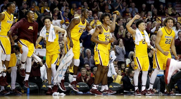 Players on the Gophers bench reacted to a basket by a teammate in the final minute of the game. Minnesota beat Nebraska by a final score of 88-73.