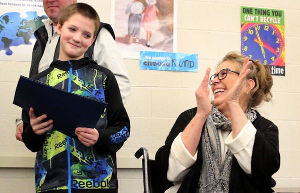 Colby Hansen, 11, was a bit shy but happy to receive some well-deserved applause from Laurie Harms, who helped honor Colby on Tuesday for coming to he
