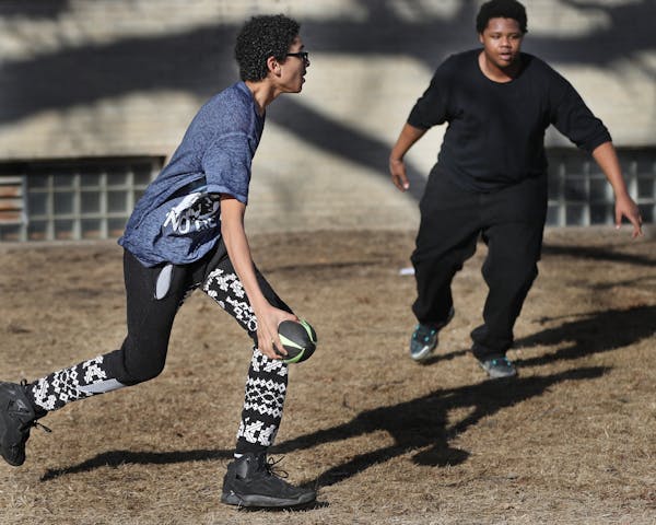 Sanitese Franco, left, 16, tried to run past Quintin Dye,16, right, during a game of flag football in a high school phy ed class Tuesday at Minnesota 