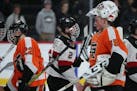 Grand Rapids goaltender Zach Stejskal (35), who stopped 49 shots on goal, shakes hands with the Eden Prairie players following the game