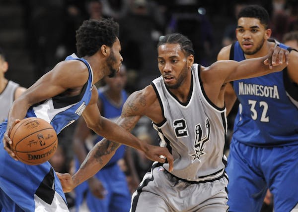 Spurs forward Kawhi Leonard (2) guarded Timberwolves forward Andrew Wiggins during the second half Saturday. San Antonio won 97-90 in overtime.